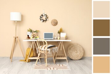 Workplace with laptop and Easter decor near beige wall in office. Different color patterns