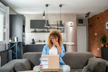 Woman is crying while unboxing a package at home