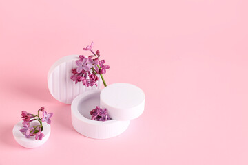Lilac flowers with plastic figures on pink background