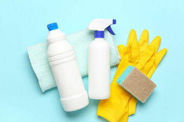Different cleaning supplies on blue background