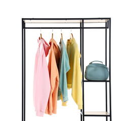 Shelving unit with hoodies and bag on white background