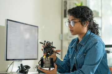 Asian engineer codes remotely, merging tech innovations with software expertise.