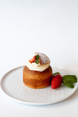 Indulge in a Delicious Strawberry Dessert Topped with Whipped Cream and Fresh Mint Leaves