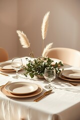 Dining Table with Neutral Plates, Glasses, Gold Cutlery, and Pampas Grass Decor, Natural Light Photography