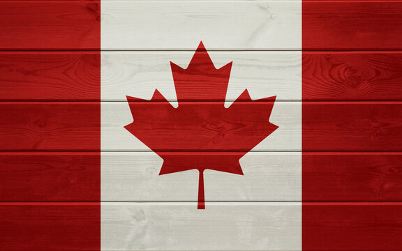 Flag of Canada on an old wooden surface.