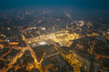 Obraz premium Night aerial drone view of illuminated Milano Duomo, Italy, lights