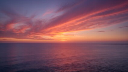 Fototapeta premium Vibrant sunset over calm ocean, painted sky with fiery hues