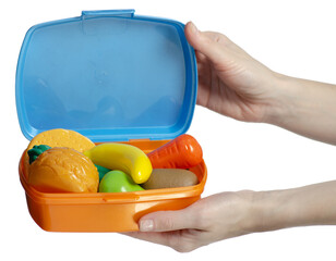 Hand holding collection of plastic food inside an orange container lunch box on white background...