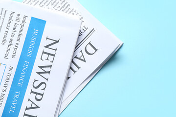 Different newspapers on blue background