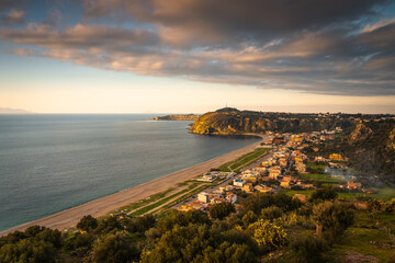 Milazzo, Sicily, Italy. Panorama of the city at sunset.	Sunset over the coast