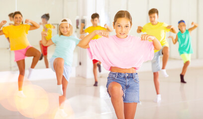 Naklejka premium Group of children are learning dance moves in a modern studio