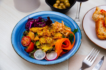 Delicious breaded chicken fillets with mustard vinaigrette and vegetables