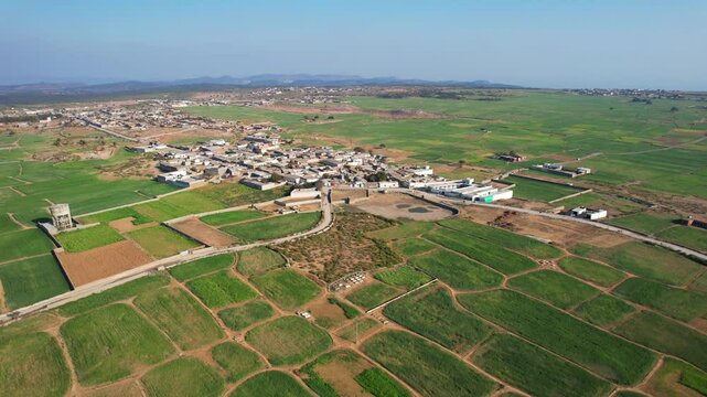 Aerial view of village between hills in Chakwal, Pakistan.