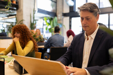 Diverse team collaborating in modern coworking space