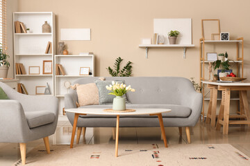 Interior of stylish living room with sofa, coffee table and shelving unit
