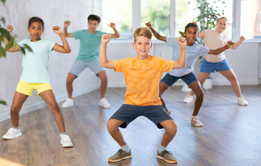 Dance studio - happy girls and boys in dance lesson