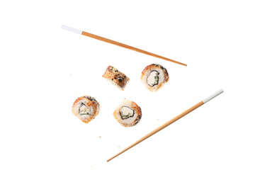 Tasty flying sushi rolls and chopsticks on white background