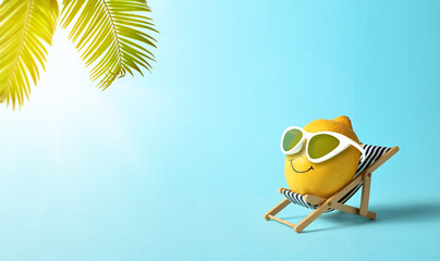 Lemon in sunglasses relaxes on lounge chair on beach. Summer concept.