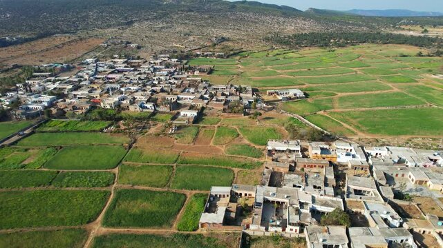 Aerial view of village between hills in Chakwal, Pakistan.