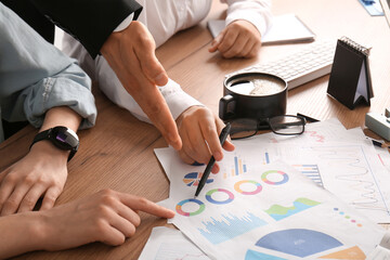 Business team working with diagrams during meeting in office, closeup