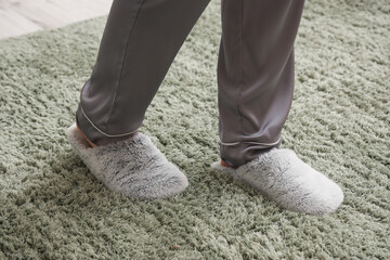 Woman in slippers walking on soft carpet. New beginning concept