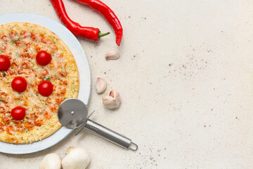 Tasty pizza, cutter and ingredients on light background