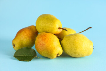 Sweet ripe pears on blue background