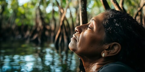 A serene woman of South Asian descent enjoys a moment of tranquility in the mangroves.