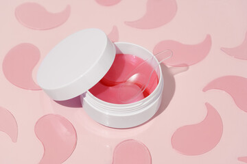 Pattern of pink hydrogel patches and white mockup jar with spatula on pink background. Concept of...
