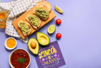 Sandwiches with traditional Mexican guacamole and Cinco de Mayo greeting card on lilac background