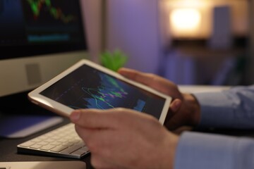 Stock exchange. Man working in office at night, closeup
