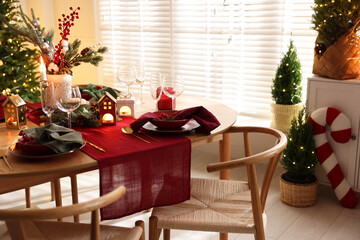 Christmas table setting with stylish dishware and festive decor indoors