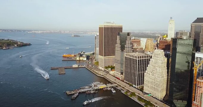 San Francisco skyline at sunrise. Aerial drone capture of Embarcadero, Ferry Terminal, South Street Seaport in San Francisco. Zoom out video with the Manhattan Downtown panoramic view - 4k