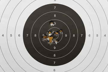 Bullseye shredded to pieces: close-up of bullet impacts demonstrating shooting accuracy and skill