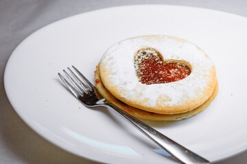 Heart-Shaped Linzer Cookie with Jam Filling and Powdered Sugar