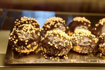 Chocolate Covered Profiteroles with Nut Topping