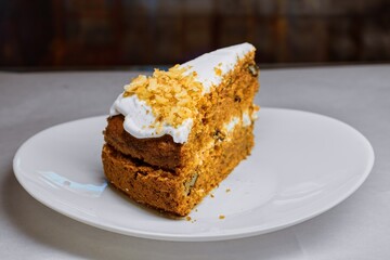 Rustic Carrot Cake Slice with Cream Cheese Frosting and Walnuts