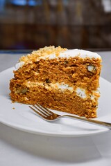 Homemade Carrot Cake Slice with Cream Cheese Frosting and Walnuts