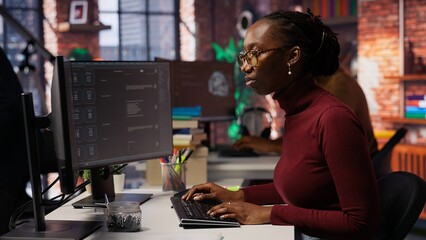 IT startup worker using large language model application to get help with coding tasks. Woman...