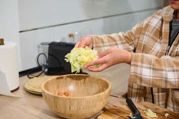 Preparing Fresh Salad in a Cozy Home Kitchen
