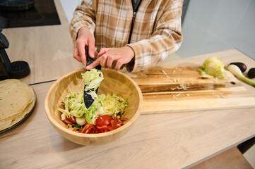 Preparing a Fresh Salad in a Cozy Home Kitchen Setting