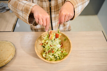 Preparing a Fresh Salad in a Cozy Home Kitchen Setting