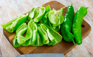 Chopped green pepper on kitchen table. Preparing food concept.