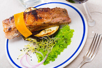 Delicious meat dish - baked pork rib with cheese and grilled eggplants
