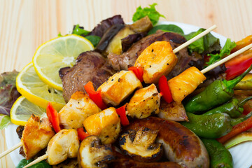 Authentic Bulgarian dish Meshana skara - various types of grilled meat and sausages with vegetables