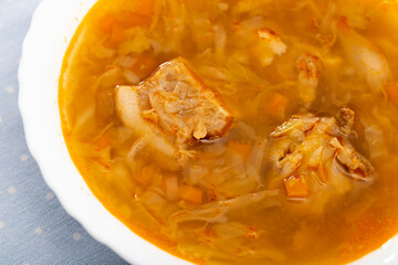 Bowl of tasty dish of Russian cuisine - sour cabbage soup (Shchi)