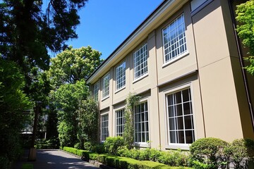 Exploring Classic Building Architecture: Exterior Facade with Lush Landscaping and a Sunny Day