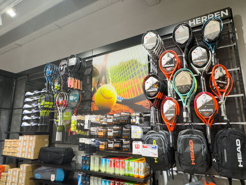 Tennis equipment store display with rackets and accessories