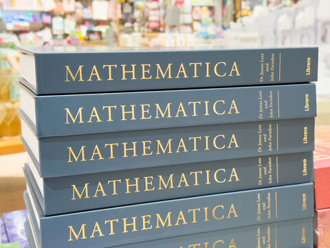 Stack of mathematica books in a busy bookstore setting
