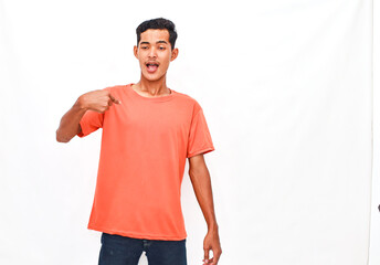 Fototapeta premium Young Person in Vibrant Top Pointing at Themself Against Plain Background